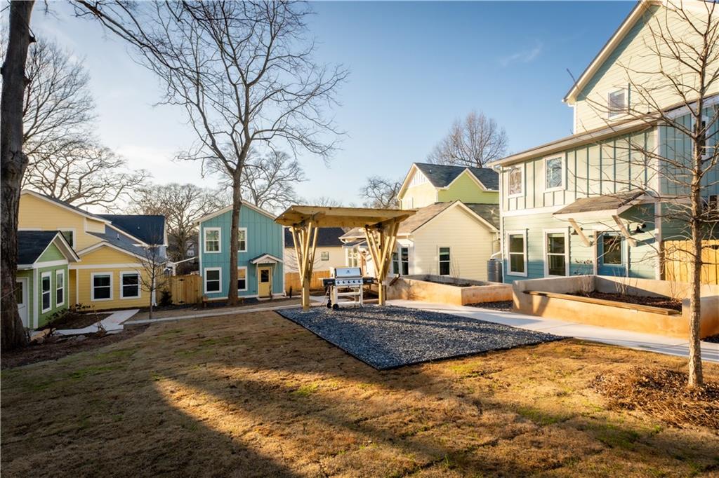 1359 Finley Street Northeast, Unit C Atlanta, GA 30307 - Photo 17 of 19 a view of a white house with a swimming pool table and chairs