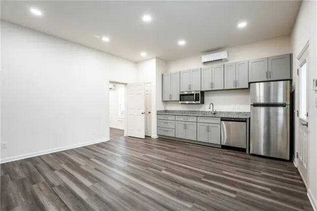 a kitchen with stainless steel appliances a refrigerator sink and cabinets