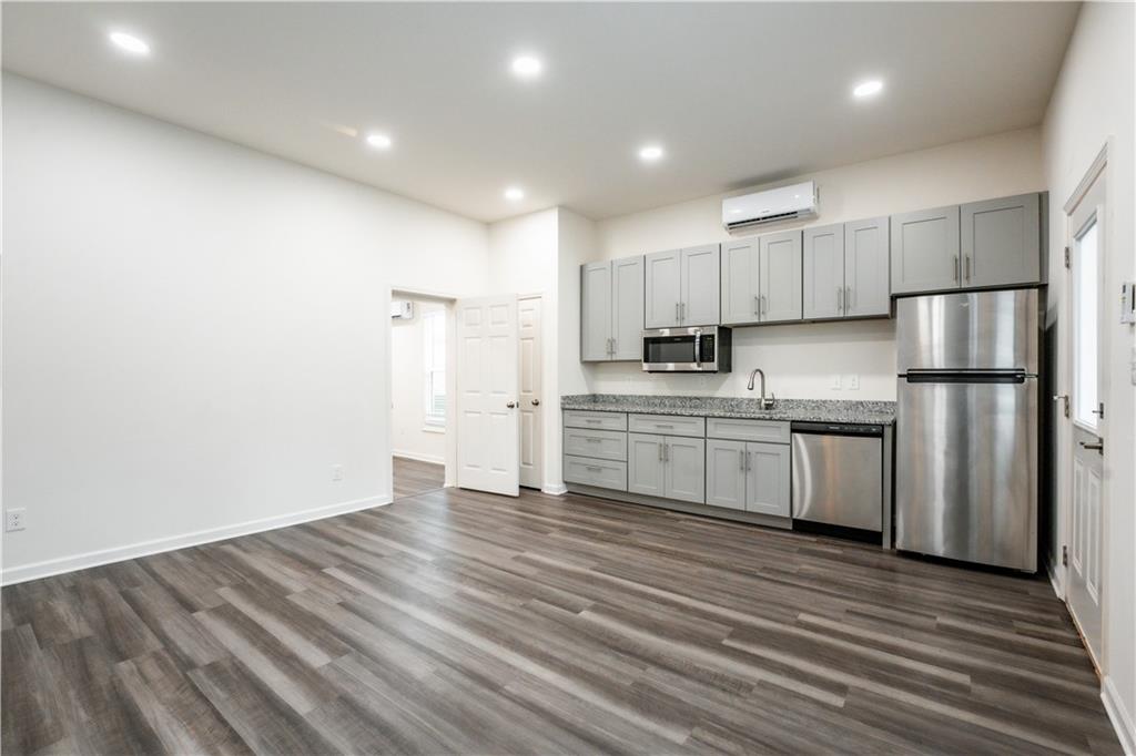 1359 Finley Street Northeast, Unit C Atlanta, GA 30307 - Photo 3 of 19 a kitchen with stainless steel appliances a refrigerator sink and cabinets