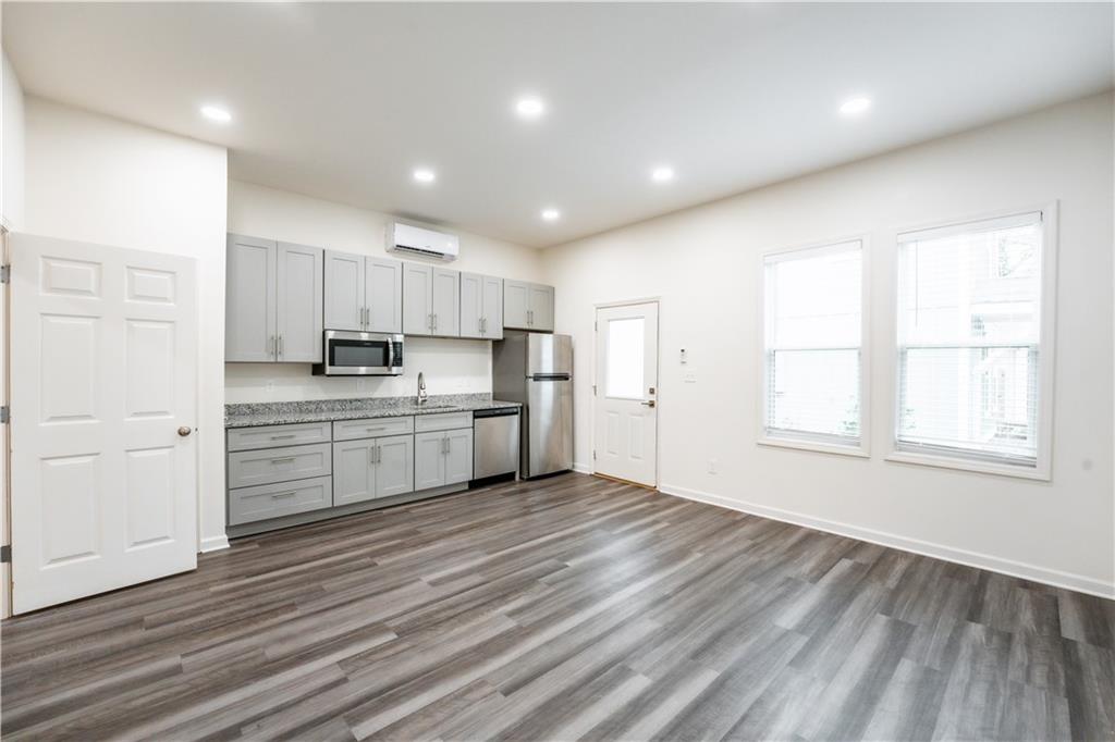 1359 Finley Street Northeast, Unit C Atlanta, GA 30307 - Photo 5 of 19 a kitchen with stainless steel appliances a refrigerator sink and cabinets