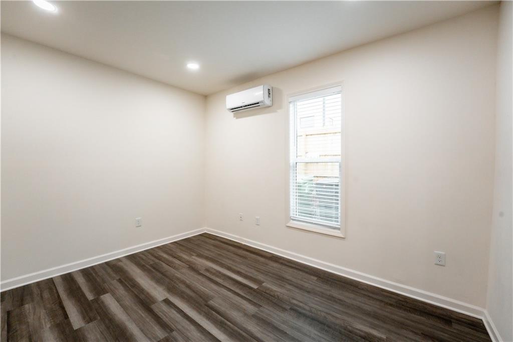1359 Finley Street Northeast, Unit C Atlanta, GA 30307 - Photo 7 of 19 an empty room with wooden floor and windows
