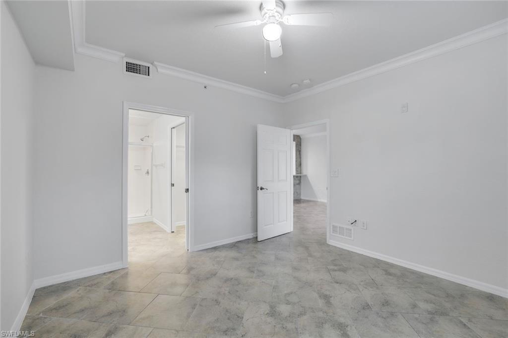 4530 Botanical Pl Circle, Unit 103 Naples, FL 34112 - Photo 12 of 32 Unfurnished bedroom with crown molding and ceiling fan