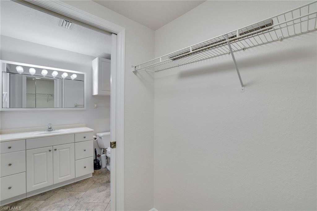 4530 Botanical Pl Circle, Unit 103 Naples, FL 34112 - Photo 16 of 32 Walk in closet with sink