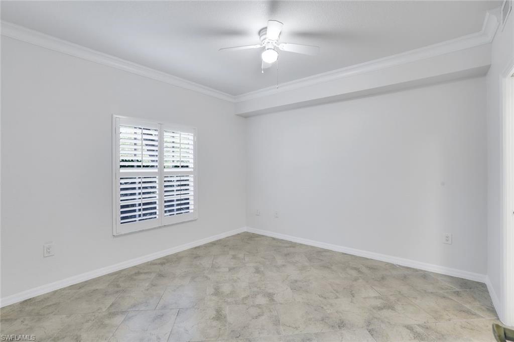 4530 Botanical Pl Circle, Unit 103 Naples, FL 34112 - Photo 17 of 32 Unfurnished room featuring crown molding and ceiling fan