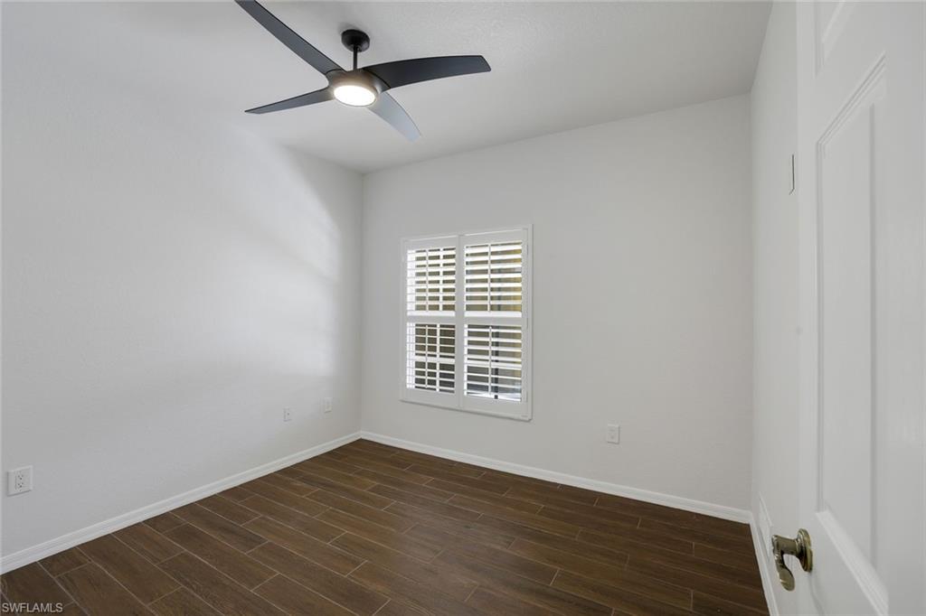 4530 Botanical Pl Circle, Unit 103 Naples, FL 34112 - Photo 20 of 32 Spare room featuring ceiling fan and dark hardwood / wood-style flooring