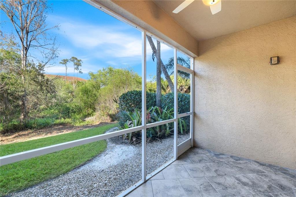 4530 Botanical Pl Circle, Unit 103 Naples, FL 34112 - Photo 24 of 32 Unfurnished sunroom with ceiling fan