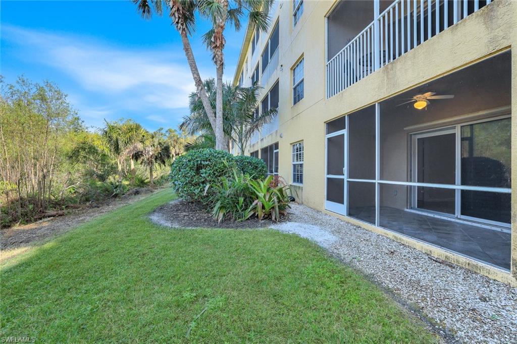 4530 Botanical Pl Circle, Unit 103 Naples, FL 34112 - Photo 25 of 32 View of yard featuring ceiling fan and a patio area