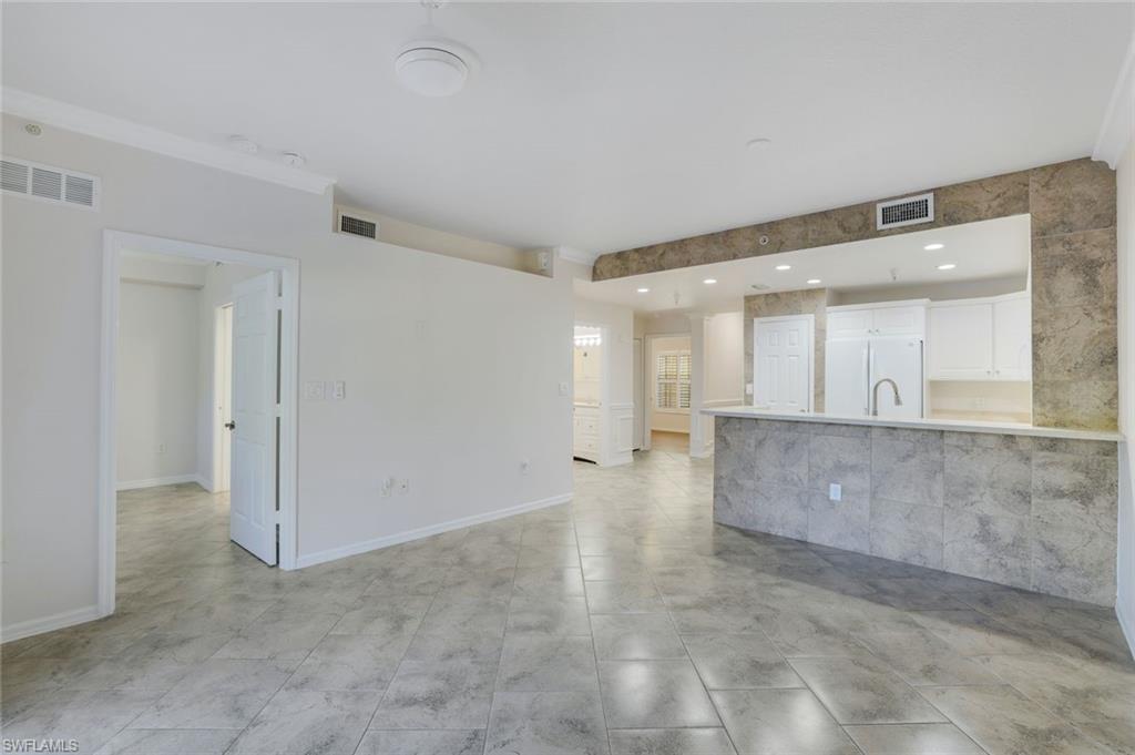 4530 Botanical Pl Circle, Unit 103 Naples, FL 34112 - Photo 6 of 32 View of unfurnished living room