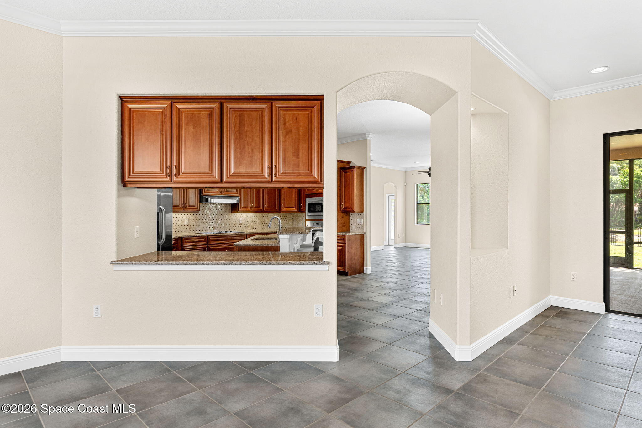 4148 Anlow Road Melbourne, FL 32904 - Photo 11 of 67 a view of a kitchen with kitchen island a sink a refrigerator and a stove