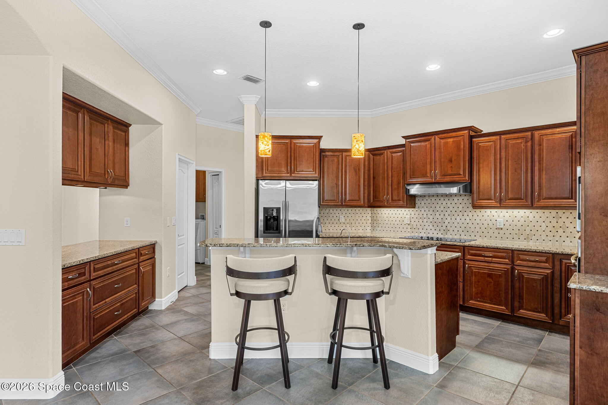 4148 Anlow Road Melbourne, FL 32904 - Photo 13 of 67 a kitchen with stainless steel appliances granite countertop a sink a stove a refrigerator cabinets and chairs