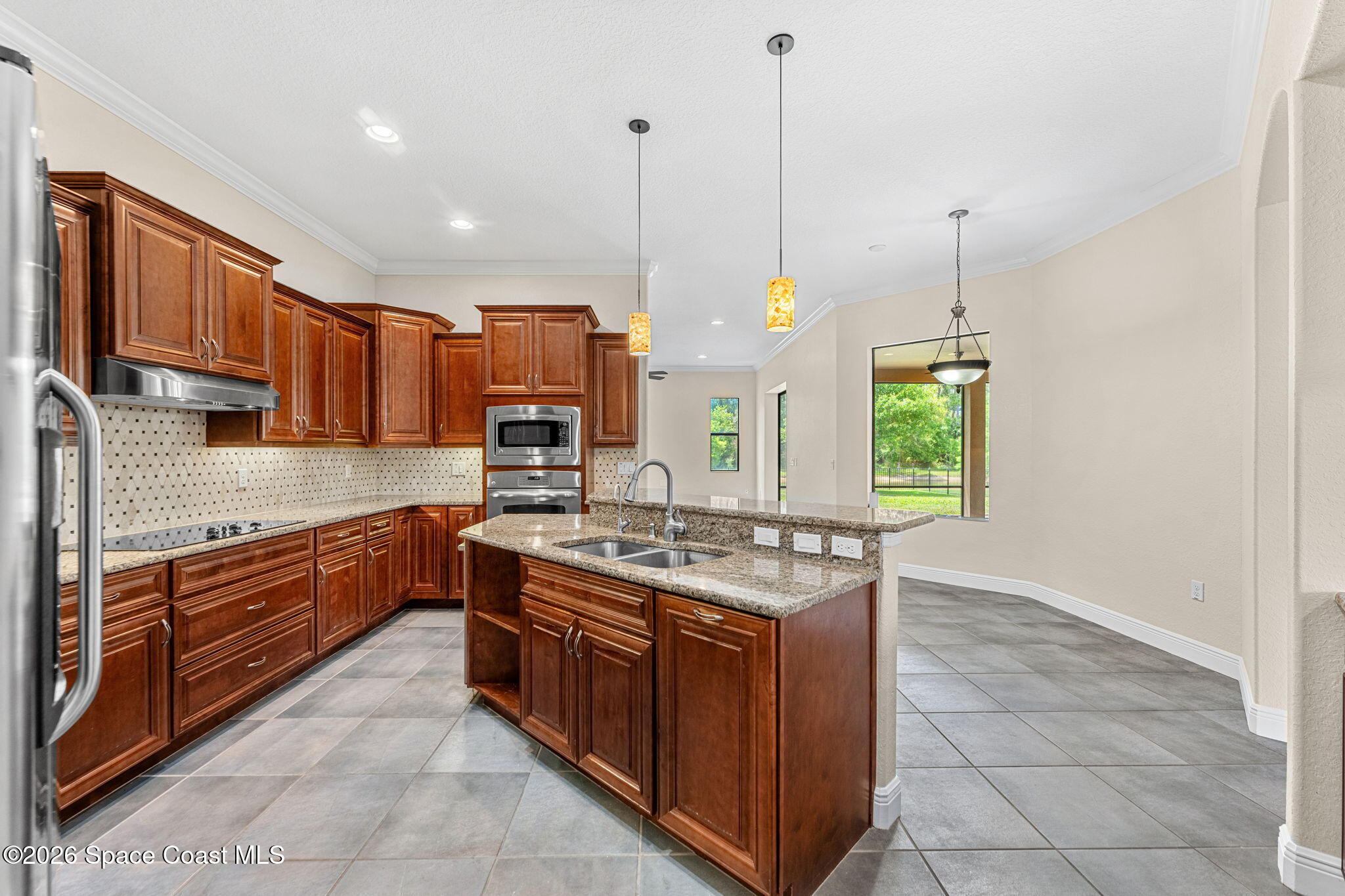4148 Anlow Road Melbourne, FL 32904 - Photo 14 of 67 a kitchen with stainless steel appliances granite countertop a stove a sink and a wooden cabinets