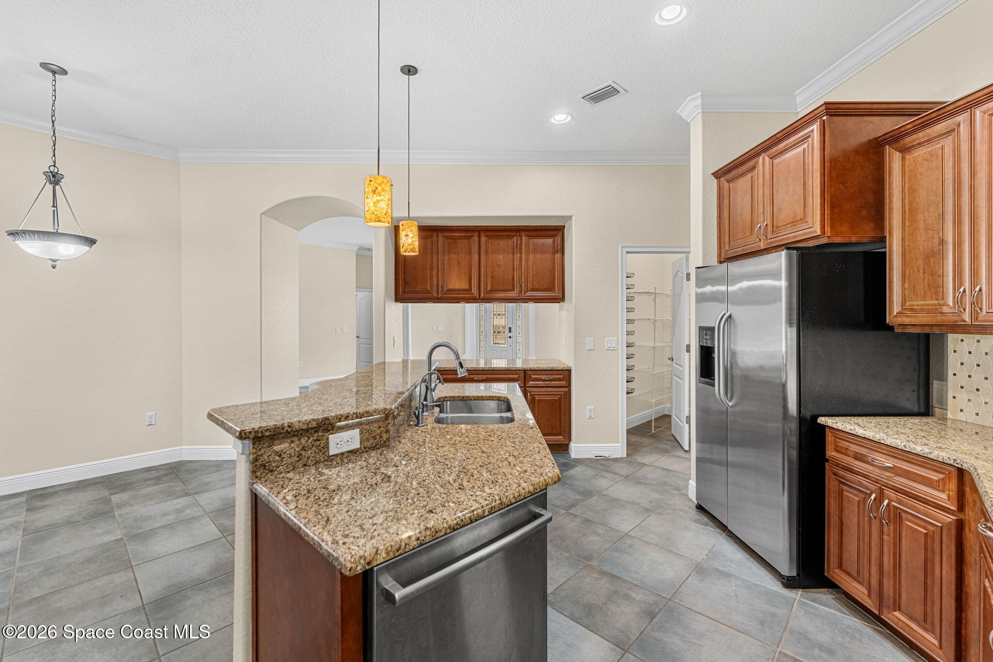 4148 Anlow Road Melbourne, FL 32904 - Photo 17 of 67 a kitchen with stainless steel appliances granite countertop a sink refrigerator and microwave