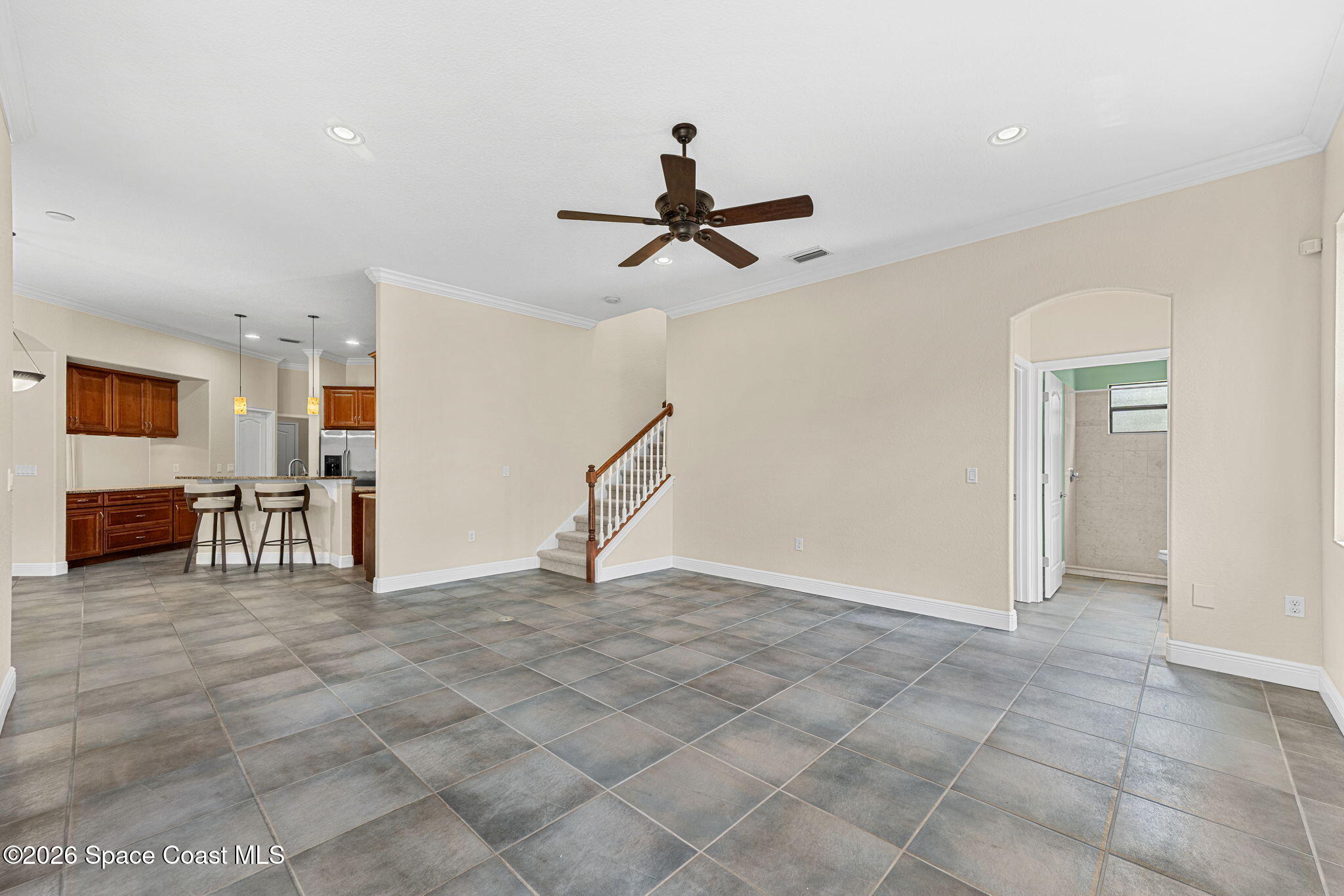 4148 Anlow Road Melbourne, FL 32904 - Photo 18 of 67 a view of a livingroom with a chandelier furniture and a ceiling fan