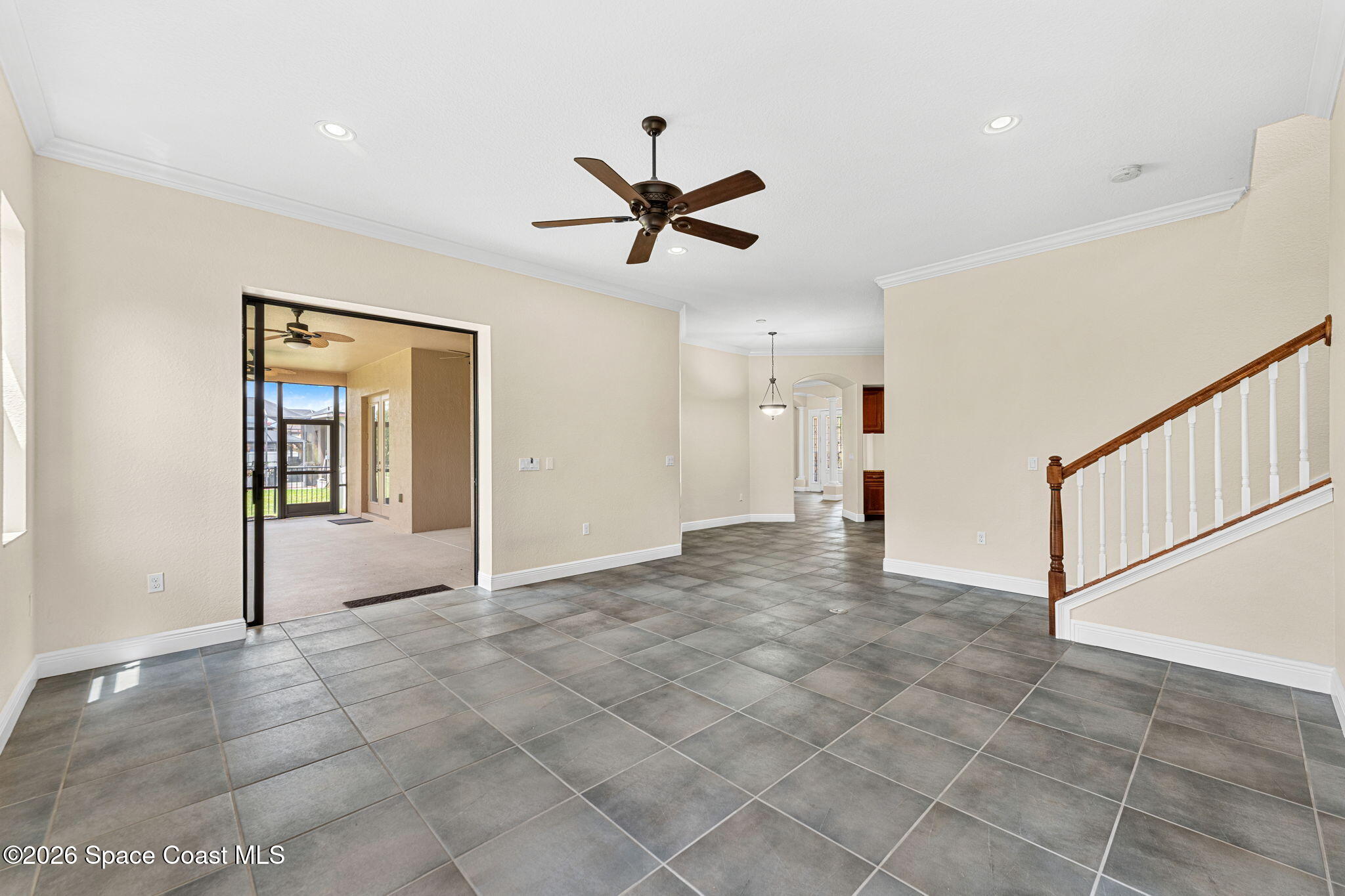 4148 Anlow Road Melbourne, FL 32904 - Photo 20 of 67 a view of a livingroom with a ceiling fan and carpet