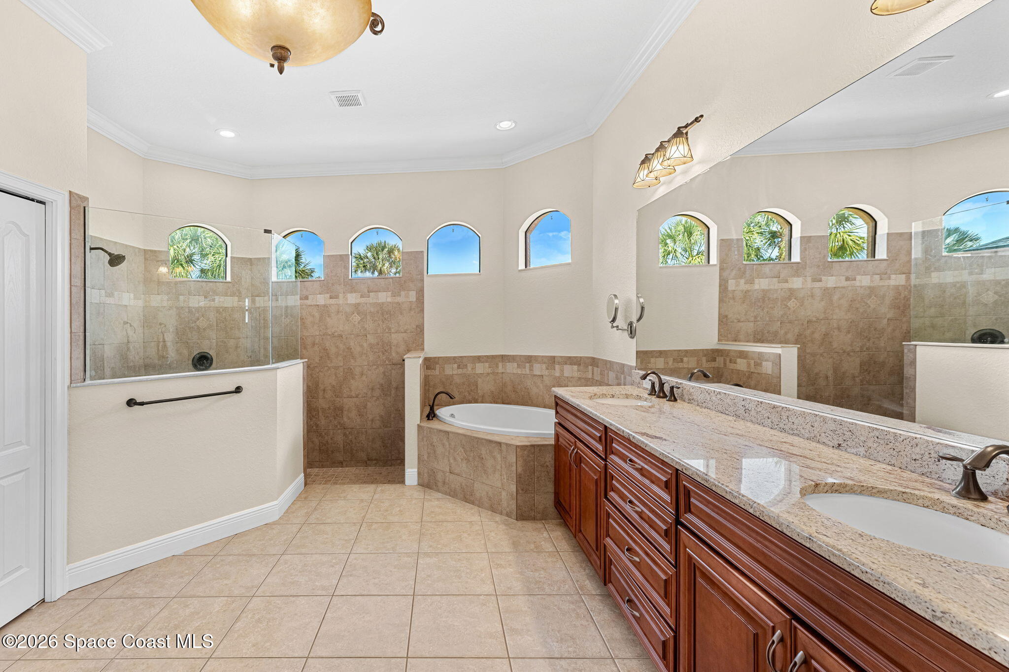 4148 Anlow Road Melbourne, FL 32904 - Photo 23 of 67 a spacious bathroom with a sink a vanity and a mirror