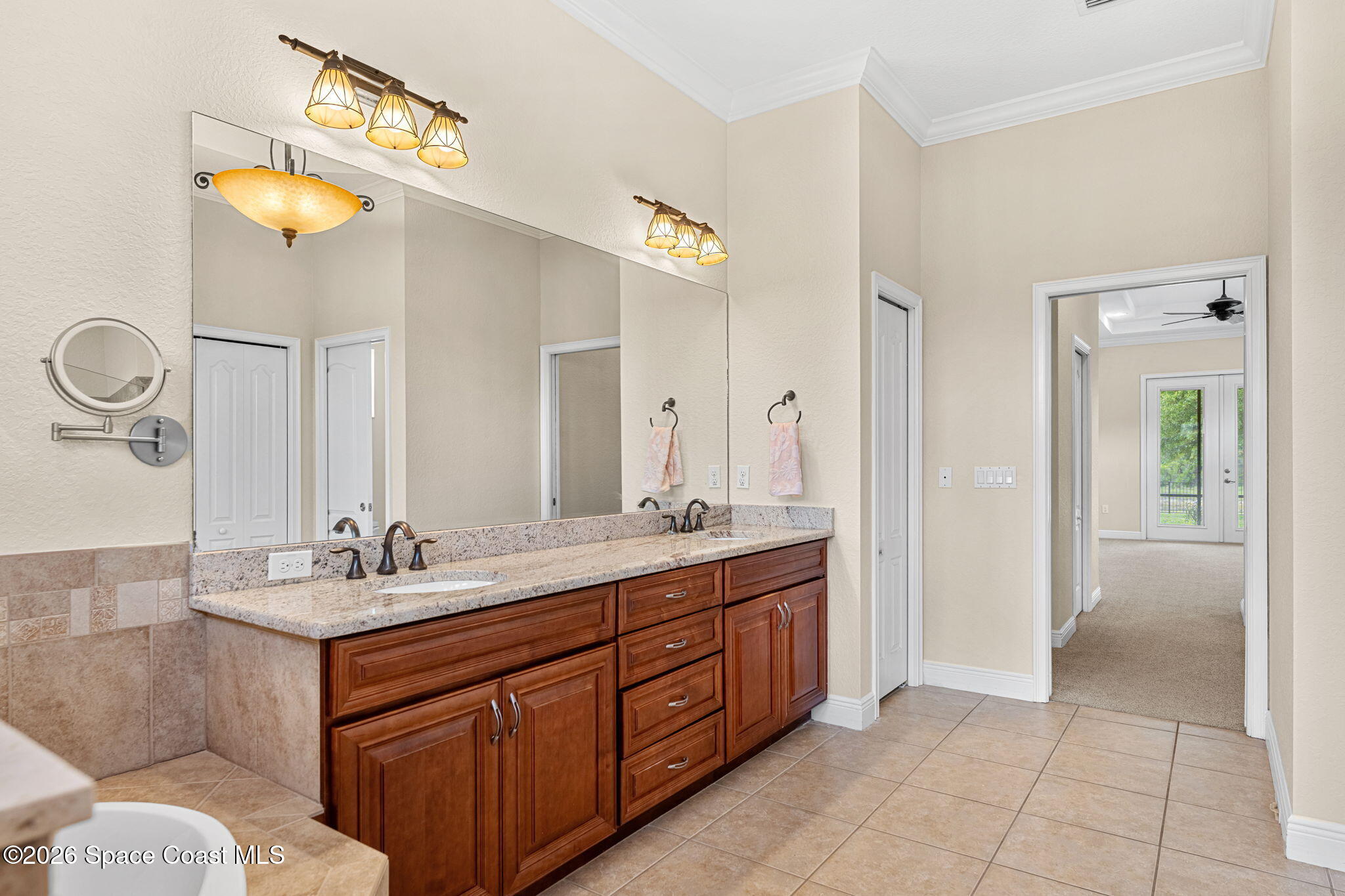 4148 Anlow Road Melbourne, FL 32904 - Photo 24 of 67 a spacious bathroom with a double vanity sink and a mirror