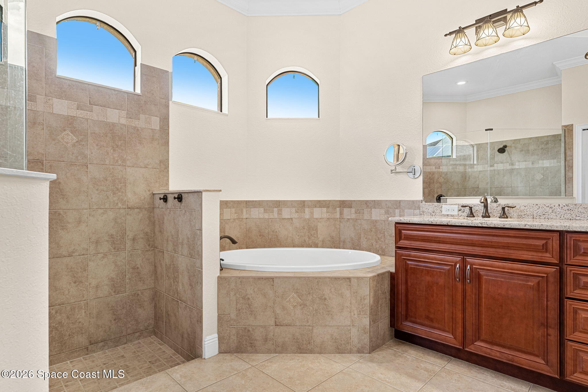 4148 Anlow Road Melbourne, FL 32904 - Photo 25 of 67 a bathroom with a sink a toilet a mirror and shower