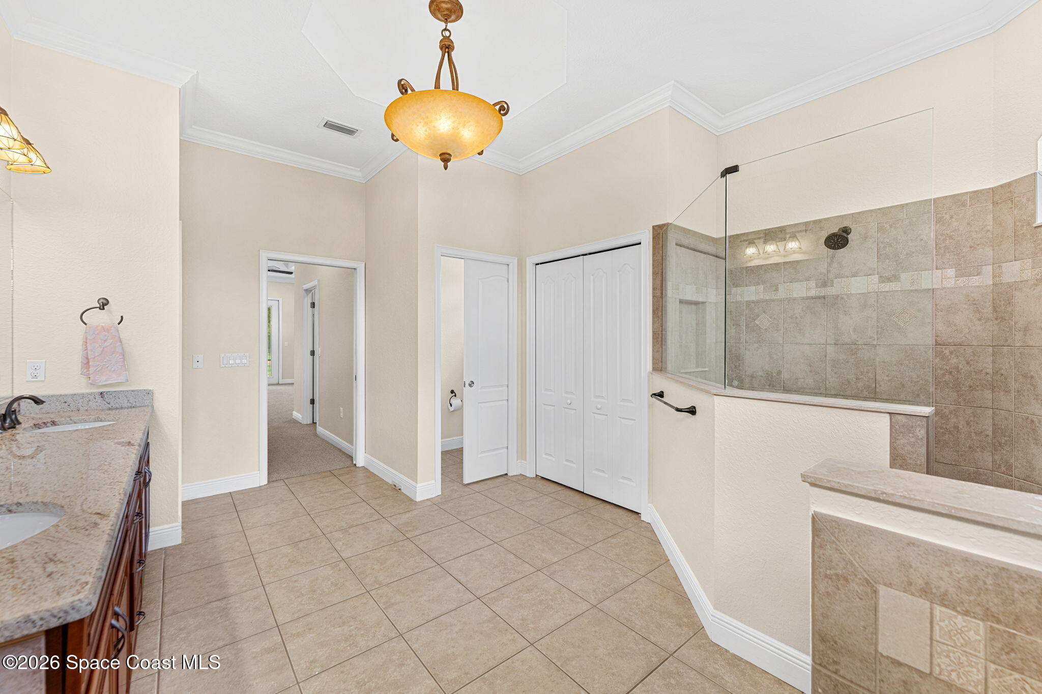 4148 Anlow Road Melbourne, FL 32904 - Photo 27 of 67 a bathroom with a granite countertop sink a mirror and shower