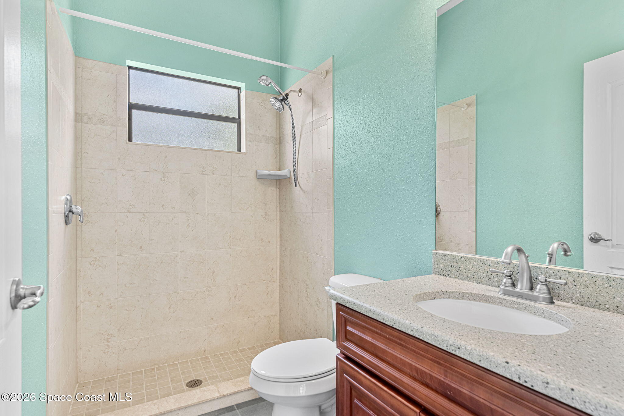 4148 Anlow Road Melbourne, FL 32904 - Photo 30 of 67 a bathroom with a granite countertop sink toilet and shower