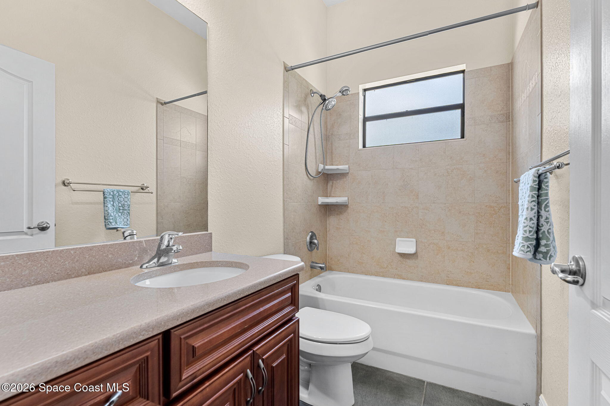 4148 Anlow Road Melbourne, FL 32904 - Photo 33 of 67 a bathroom with a sink a toilet and shower