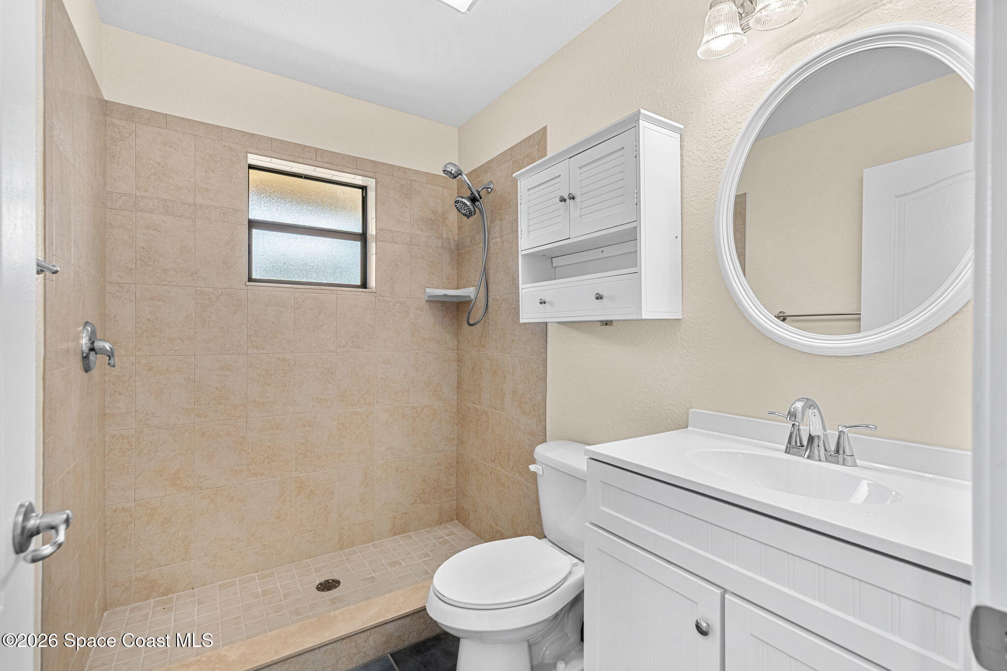4148 Anlow Road Melbourne, FL 32904 - Photo 38 of 67 a bathroom with a sink a toilet and a mirror