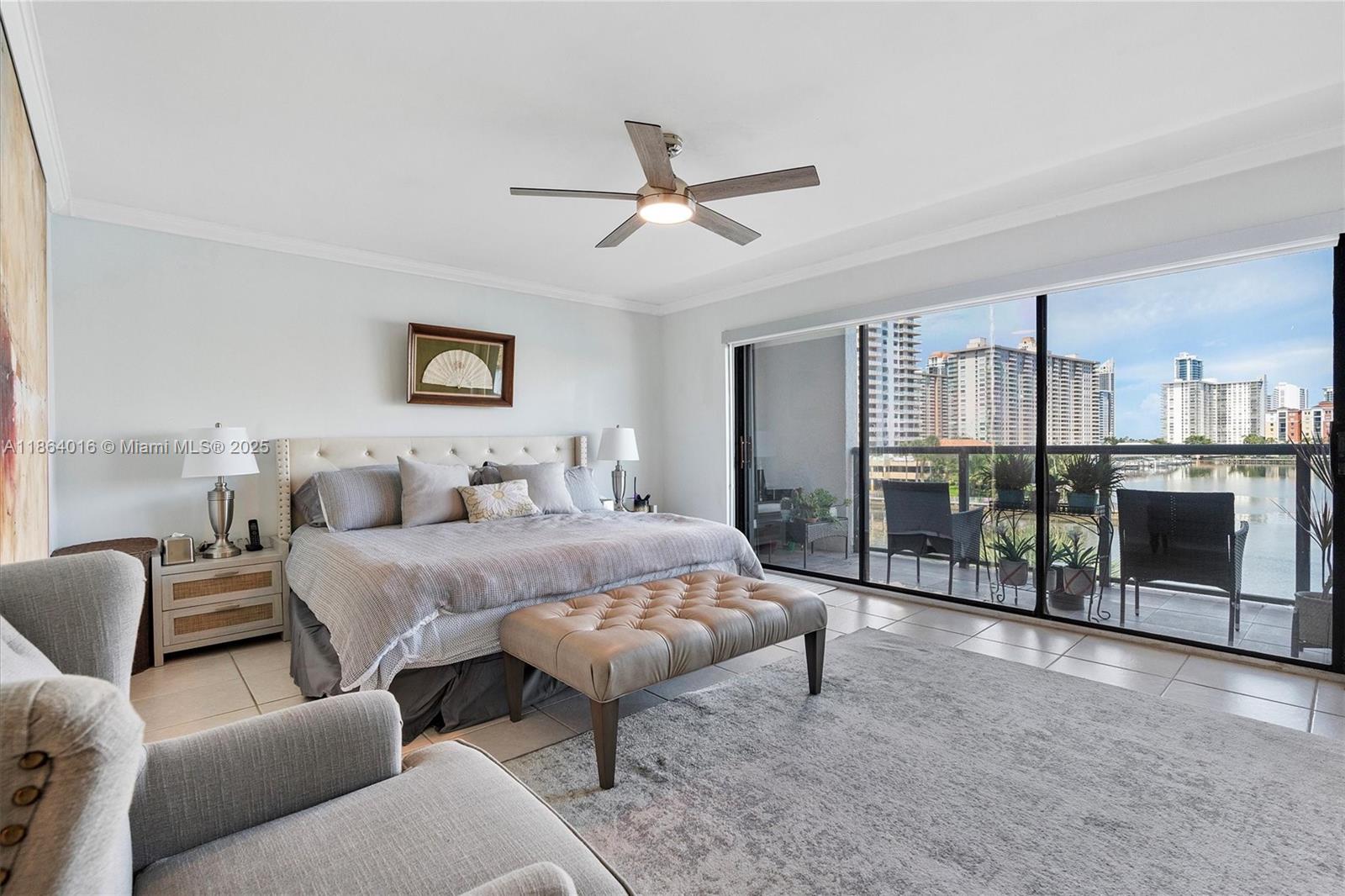 4000 Northeast 168th Street, Unit PH5A North Miami Beach, FL 33160 - Photo 12 of 33 a spacious bedroom with a bed a couch and a walk in closet