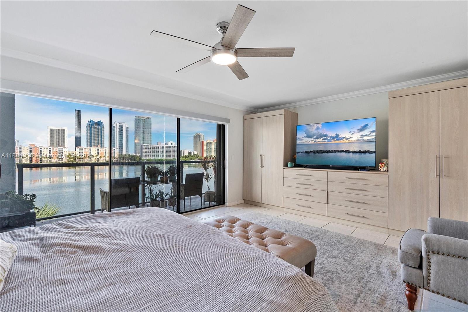 4000 Northeast 168th Street, Unit PH5A North Miami Beach, FL 33160 - Photo 13 of 33 a bedroom with furniture and window