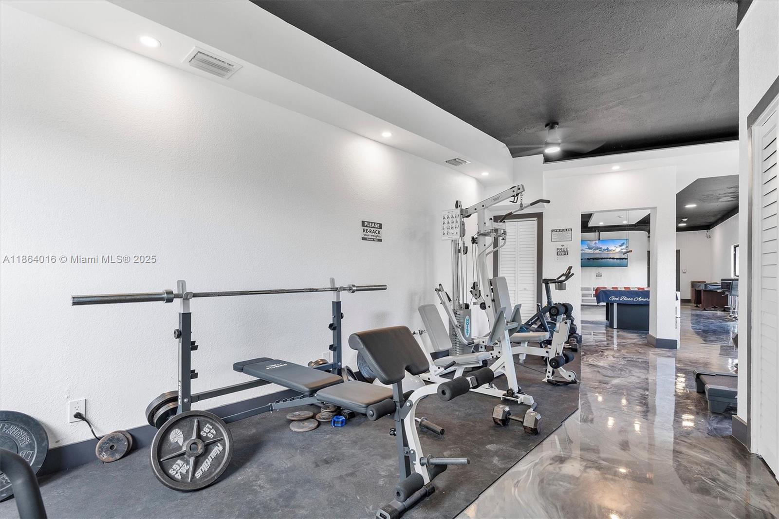 4000 Northeast 168th Street, Unit PH5A North Miami Beach, FL 33160 - Photo 21 of 33 a gym room with lots of gym equipment