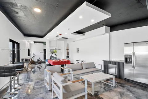 a living room with furniture and kitchen view