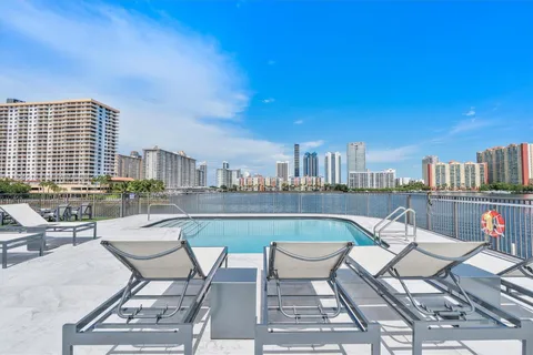 a view of a swimming pool with outdoor seating