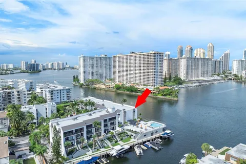 a view of a lake with boats and trees in the background