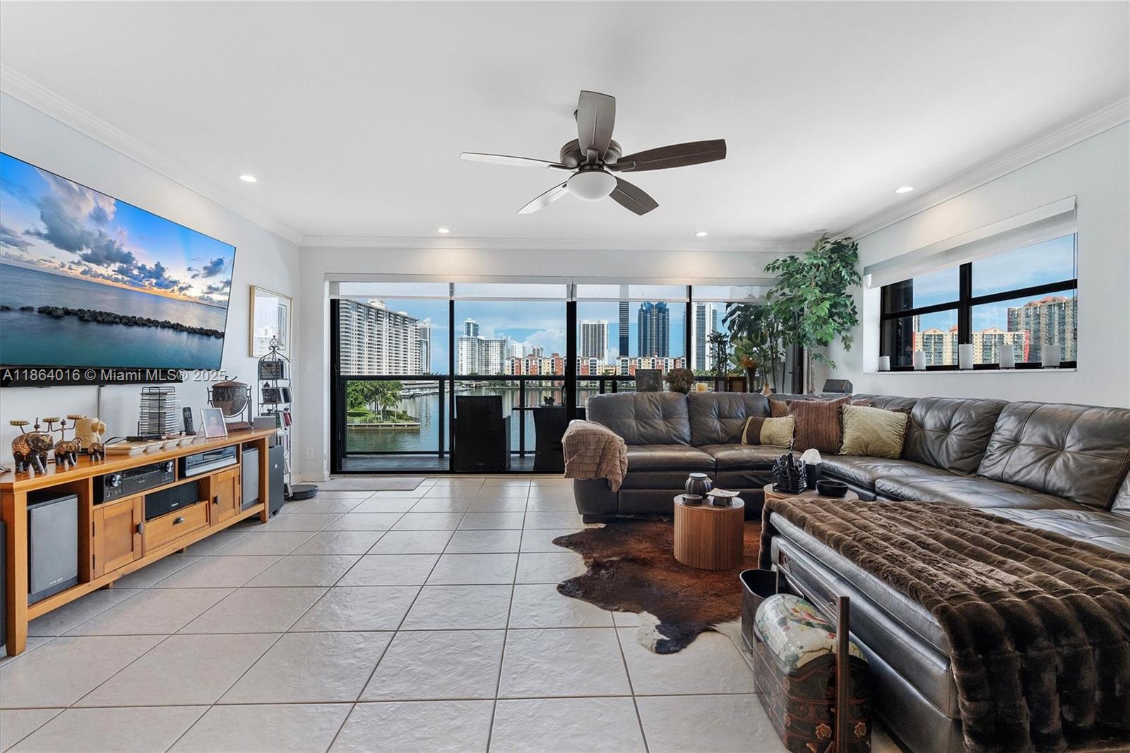 4000 Northeast 168th Street, Unit PH5A North Miami Beach, FL 33160 - Photo 3 of 33 a living room with furniture and a flat screen tv