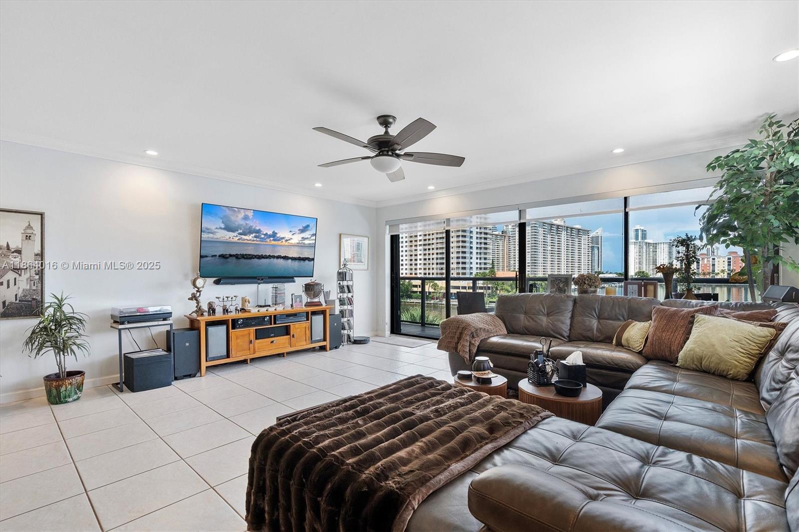 4000 Northeast 168th Street, Unit PH5A North Miami Beach, FL 33160 - Photo 5 of 33 a living room with furniture and a flat screen tv