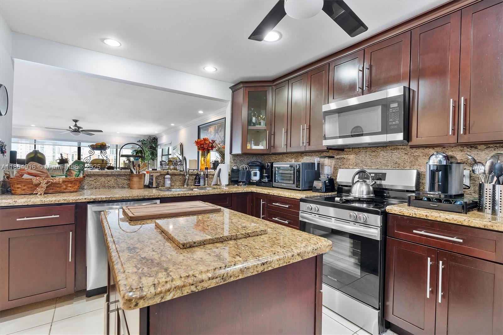 4000 Northeast 168th Street, Unit PH5A North Miami Beach, FL 33160 - Photo 7 of 33 a kitchen with granite countertop stainless steel appliances lots of counter top space