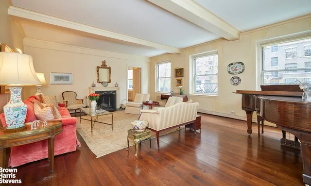 a living room with furniture a table and wooden floor
