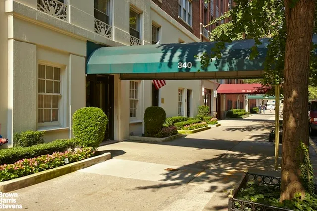 a hallway with a large mirror and a dining table with wooden floor