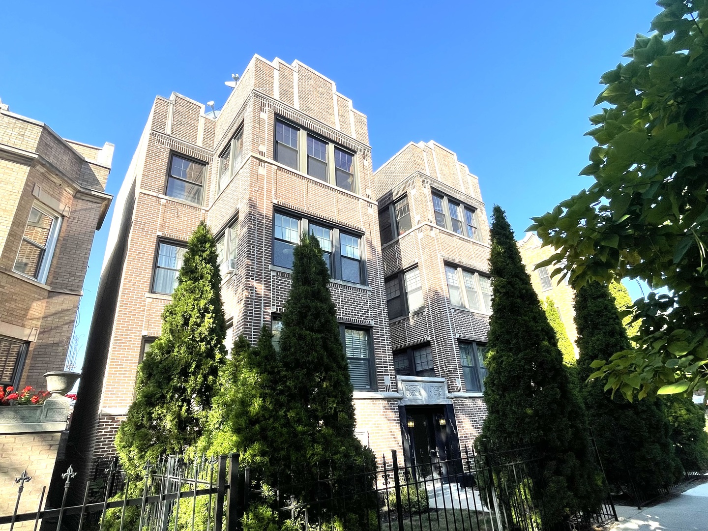 2810 West Logan Boulevard, Unit 3W Chicago, IL 60647 - Photo 1 of 34 a front view of a multi story residential apartment building with a yard