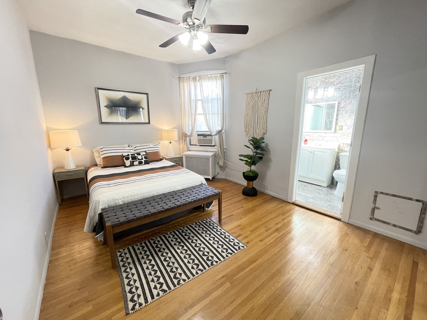 2810 West Logan Boulevard, Unit 3W Chicago, IL 60647 - Photo 12 of 34 a bedroom with a bed and wooden floor