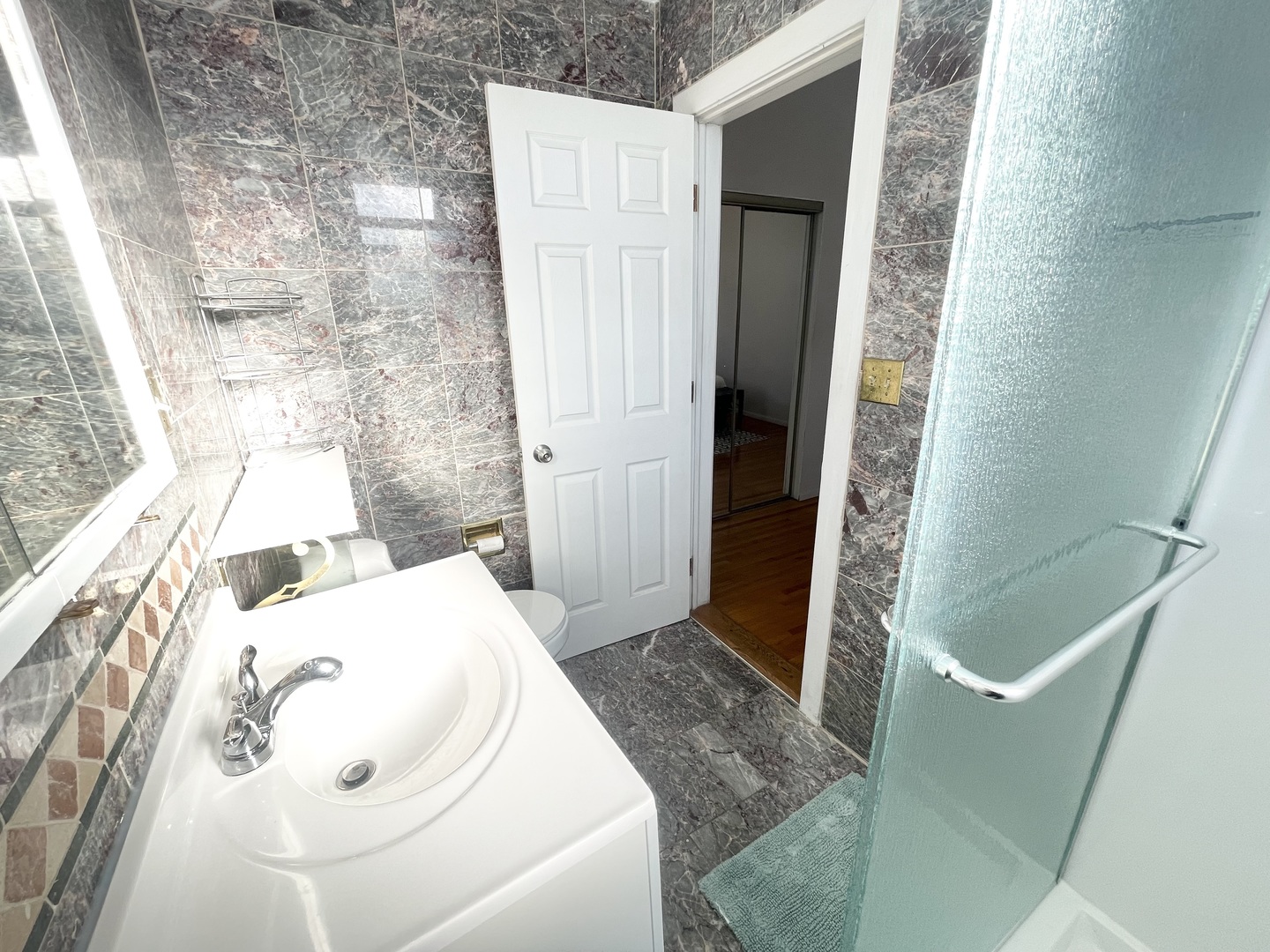 2810 West Logan Boulevard, Unit 3W Chicago, IL 60647 - Photo 15 of 34 a bathroom with a sink and shower