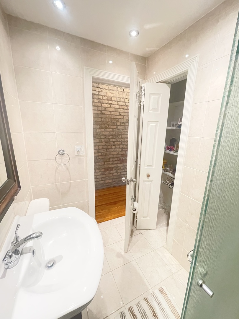 2810 West Logan Boulevard, Unit 3W Chicago, IL 60647 - Photo 19 of 34 a bathroom with a tub and shower