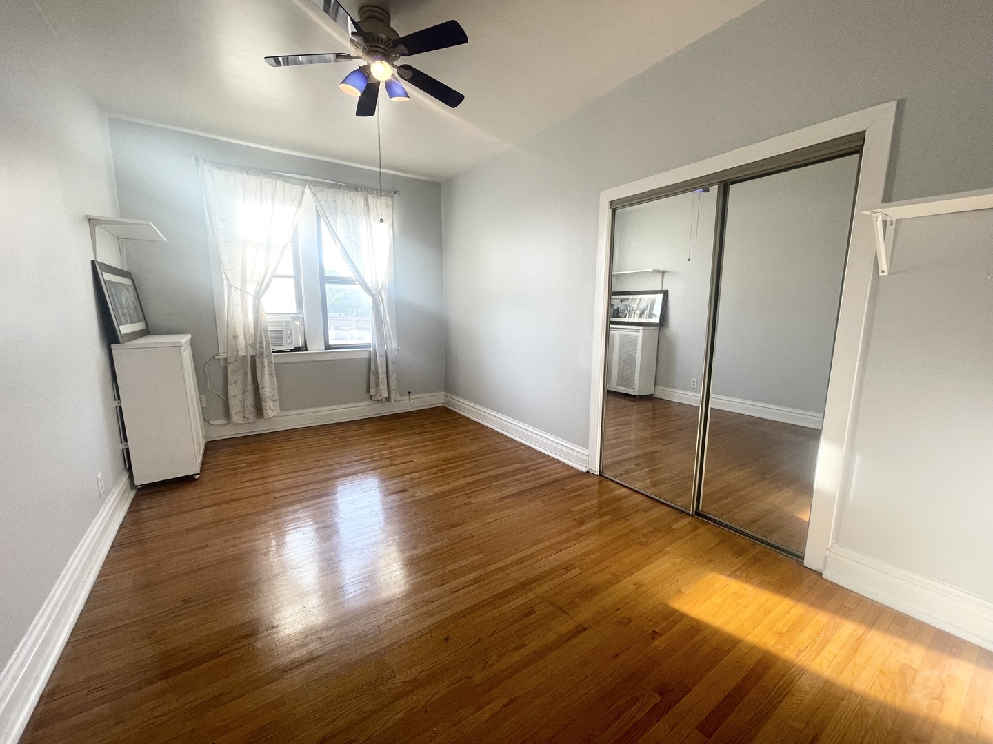 2810 West Logan Boulevard, Unit 3W Chicago, IL 60647 - Photo 20 of 34 a view of empty room with wooden floor and fan