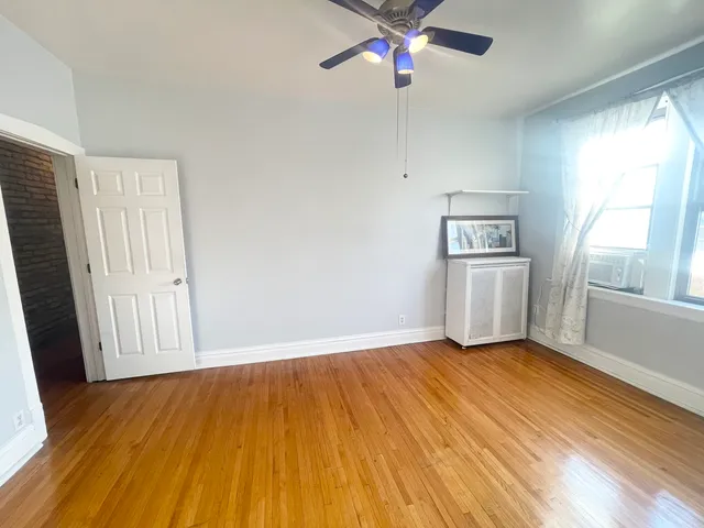 a living room with dining room and wooden floor