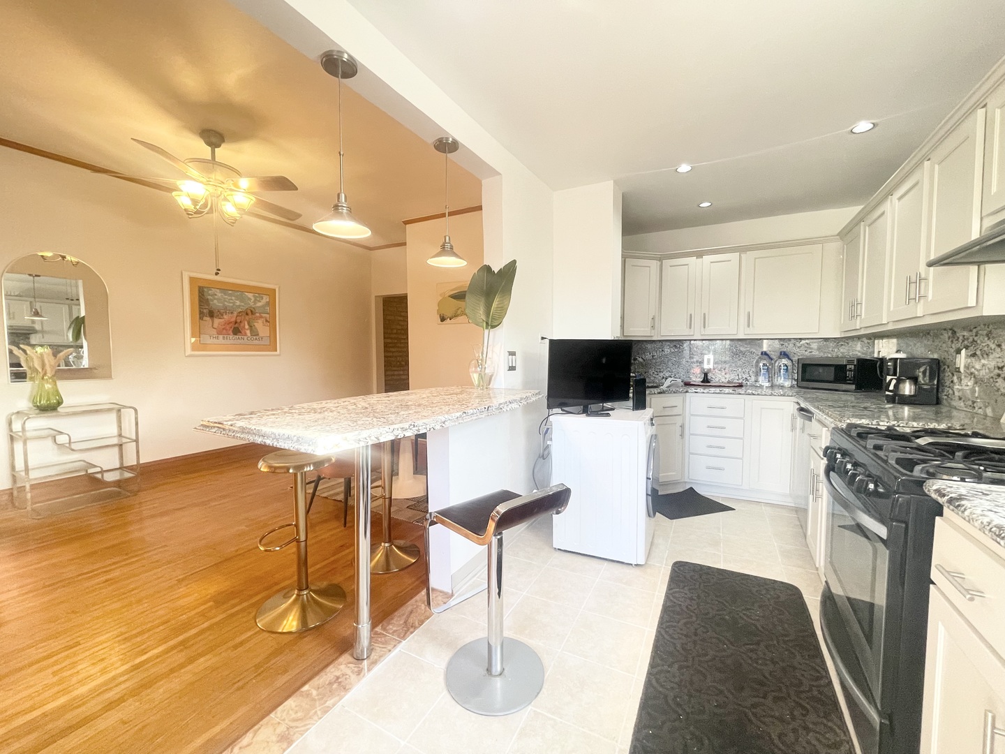 2810 West Logan Boulevard, Unit 3W Chicago, IL 60647 - Photo 24 of 34 a kitchen with stainless steel appliances kitchen island granite countertop a stove a sink and a cabinets