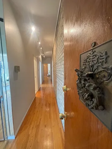 a view of a hallway view with wooden floor and staircase