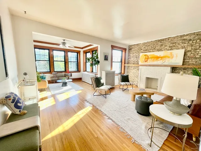 a living room with furniture and floor to ceiling windows