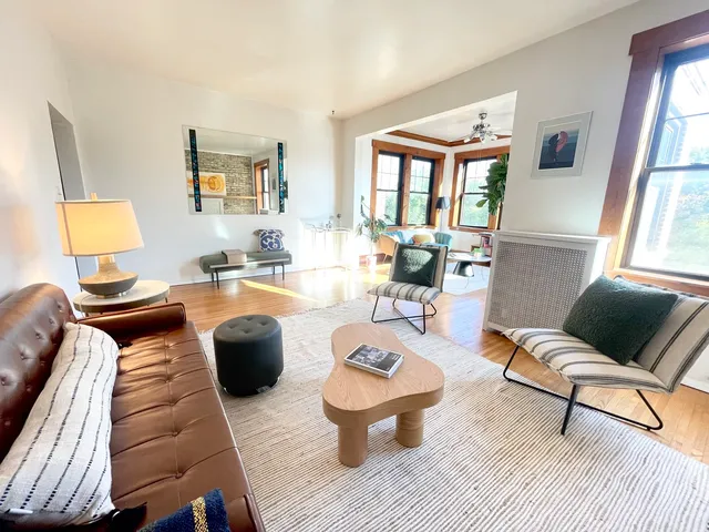 a living room with furniture and a wooden floor