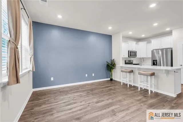 a view of kitchen with furniture and wooden floor