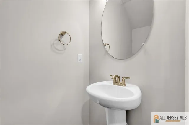 a bathroom with a sink a mirror and a toilet