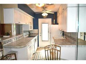 1481 South Ocean Boulevard, Unit 332C Pompano Beach, FL 33062 - Photo 1 of 24 a kitchen with a sink refrigerator and cabinets