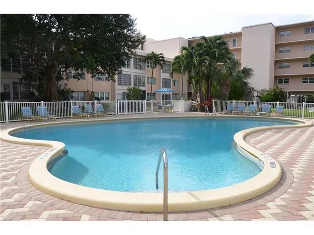 a view of a swimming pool with a lounge chairs